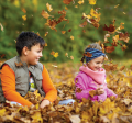 Children playing in fall leaves.